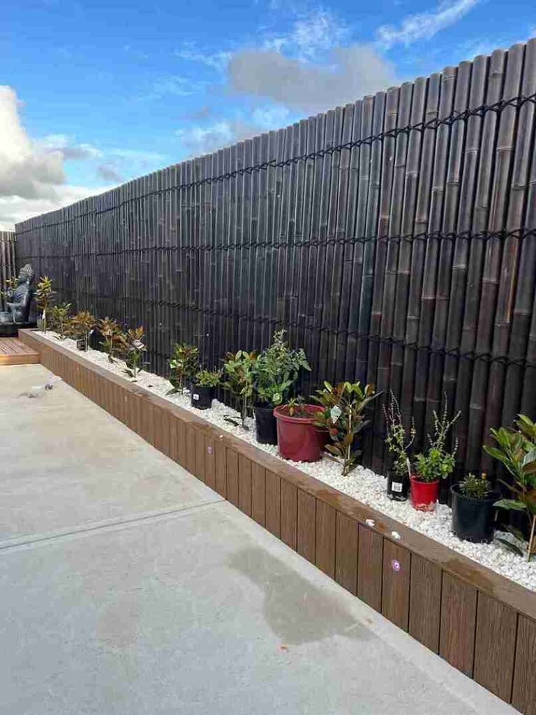 Bamboo Fence with Potted Plant Border & Buddha Statue