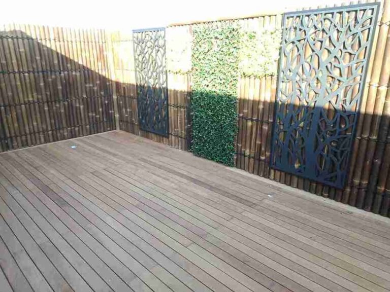 Decorative Metal Art Panels on Bamboo Fence